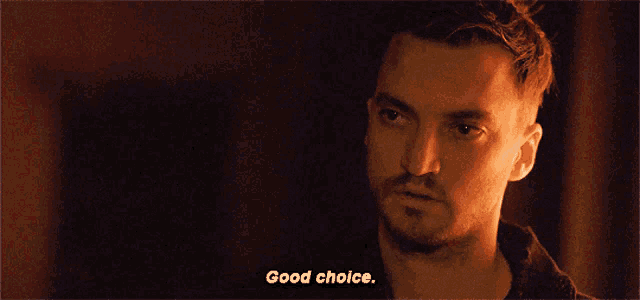 a man in a dark room with the words good choice behind him