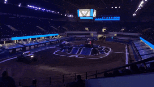 a monster truck race is going on in a stadium with a sign that says mtns