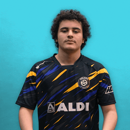 a man wearing a black shirt with aldi on the front