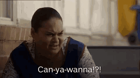 a woman is sitting in front of a window with the words `` can-ya-wanna ! '' written on her face .
