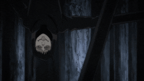 a person hanging upside down in a dark room with their face visible
