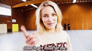 a woman is giving a thumbs up and saying do n't get mad at me