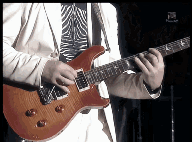 a man playing a guitar in front of a screen that says " videocraft "