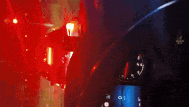 a close up of a car dashboard with a red light behind it and the numbers 0 and 1 on the screen