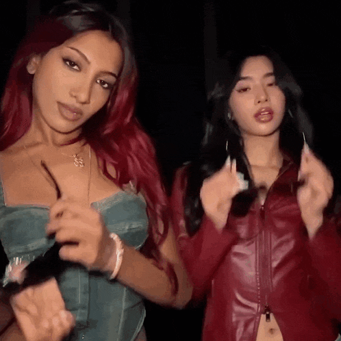two women with red hair are standing next to each other .