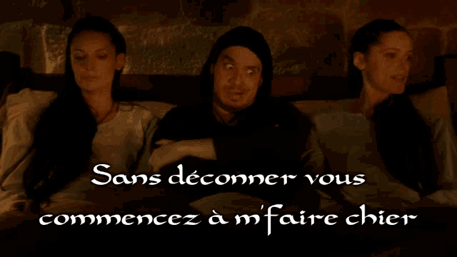 a man and two women are sitting next to each other with sans deconner vous