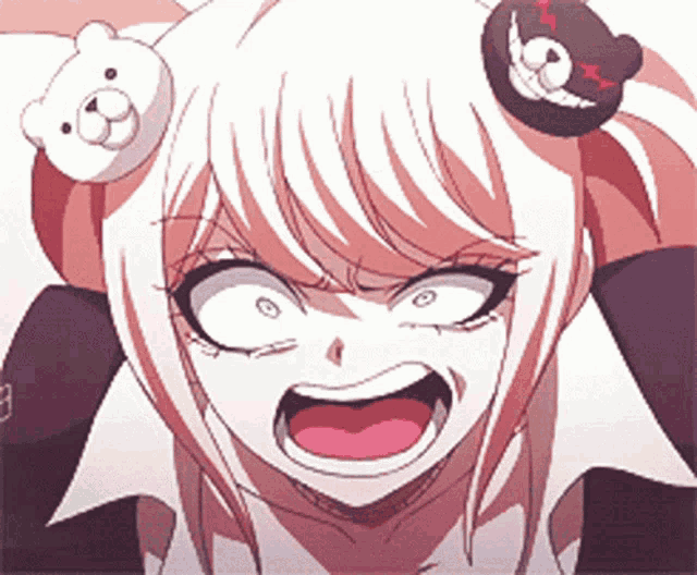 a girl with a teddy bear on her head is making a funny face .