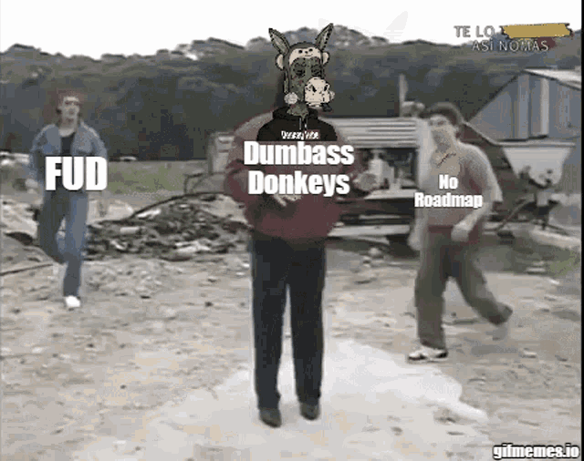 a man with a donkey on his head is standing in front of a group of people with fud and dumbass donkeys written on the screen