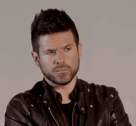 a man with a beard wearing a leather jacket