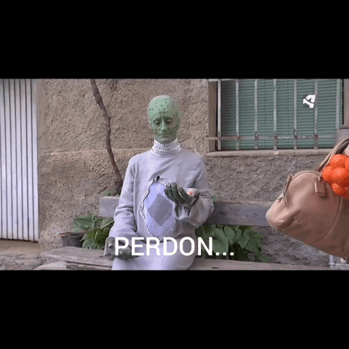 a person with green paint on their face is sitting on a bench with the word perdon written on the bottom