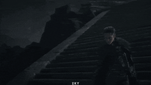 a couple of men are standing next to each other on a set of stairs .