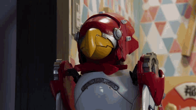 a robot with a yellow beak and a red head is standing in a room