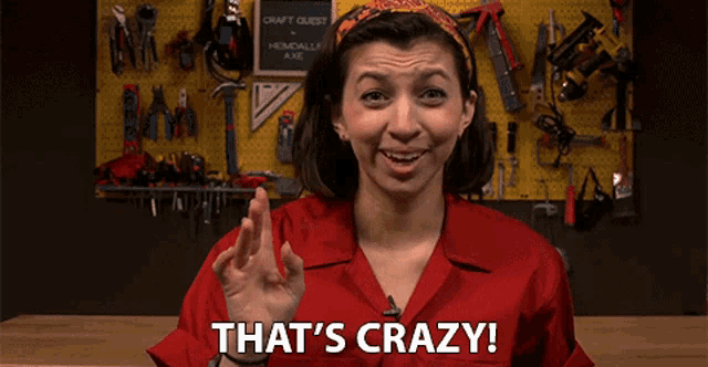 a woman says that 's crazy in front of a wall full of tools