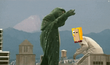a man with a yellow box on his head is standing next to another man