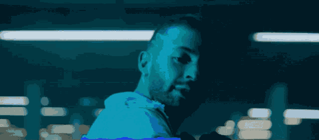 a man with a beard is wearing a blue jacket