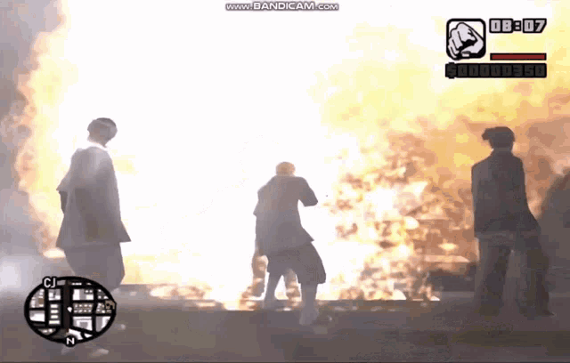 three people standing in front of a fire with a time of 09:08