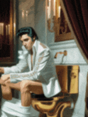 a painting of elvis presley sitting on a gold toilet