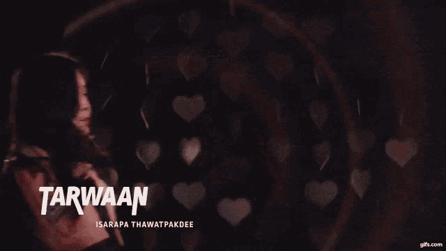 a girl in a pink jacket with the word tarwaan written on it