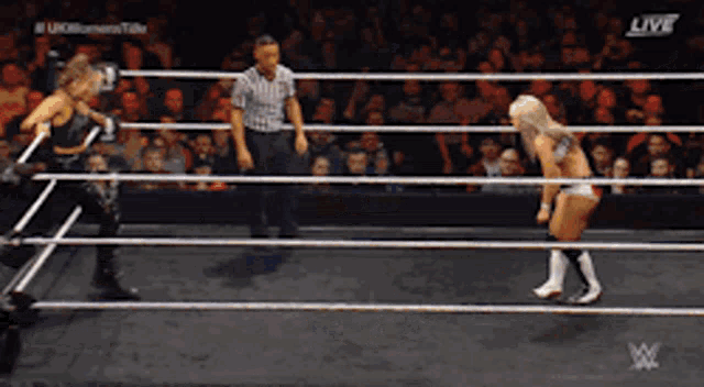 a woman in a wrestling ring with the words live on the bottom