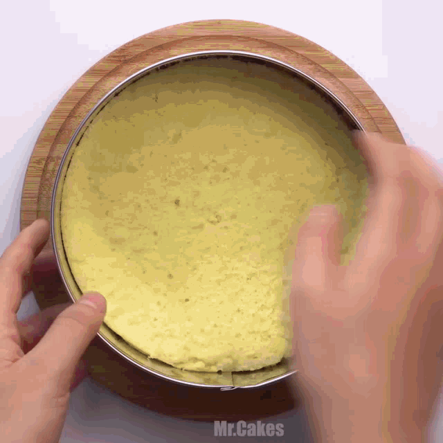 a person is making a cake and the words mr.cakes are on the bottom of the cake
