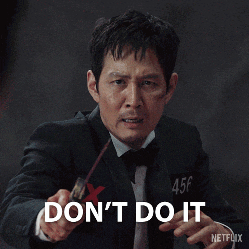 a man in a tuxedo is holding a stick and says " don 't do it "