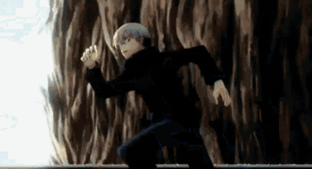 a man in a black jacket is running in front of a wall .
