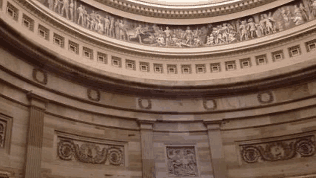 the inside of a building with a dome and a ceiling .