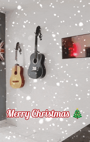 two guitars hanging on a wall with merry christmas written in red