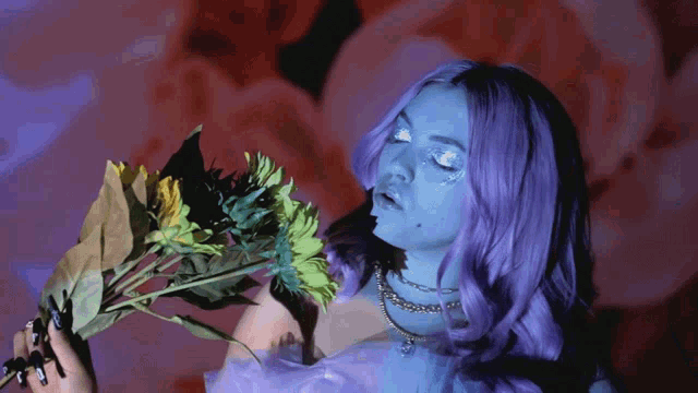 a woman with purple hair is holding a flower