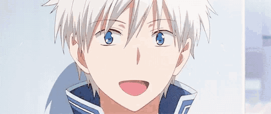 a close up of a boy with white hair and blue eyes .