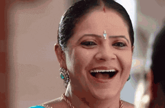 a close up of a woman laughing with her mouth open