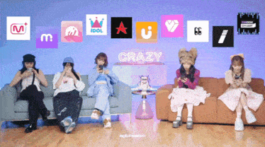a group of girls are sitting on a couch looking at their phones and the word crazy is on the bottom