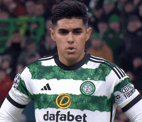 a man wearing a green and white jersey with dafabet on the front
