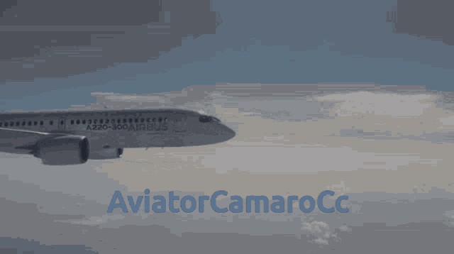 an a220 airbus is flying in the sky with the words aviator camarocc below it