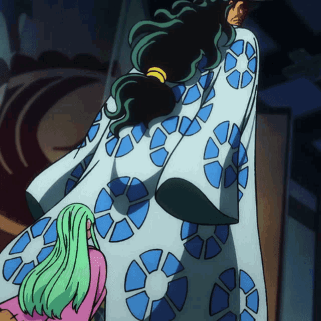 a woman with green hair is kneeling down next to a man in a blue and white robe