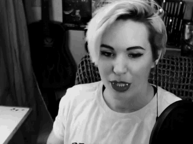 a black and white photo of a woman wearing a t-shirt that says ' a ' on it