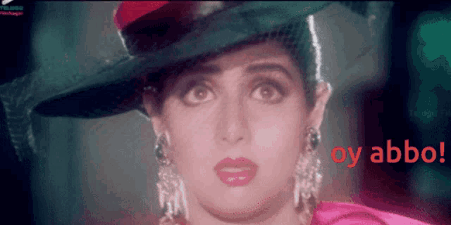 a close up of a woman wearing a hat with the words oy abbo in red
