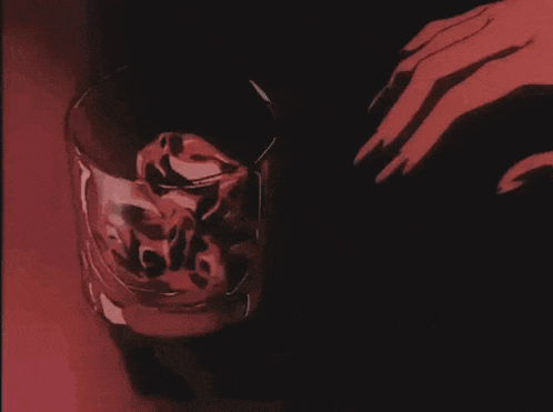 a woman is pouring a drink into a glass .
