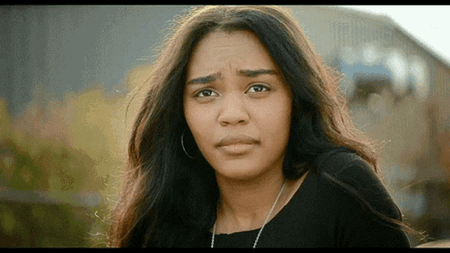 a close up of a woman 's face with a serious expression