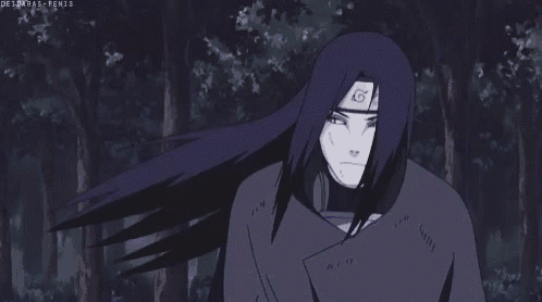 a man with long hair and a mask on his face is in the woods .
