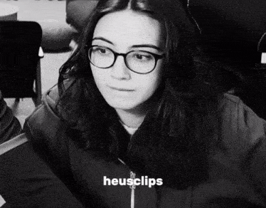 a black and white photo of a woman with glasses and the word heusclips