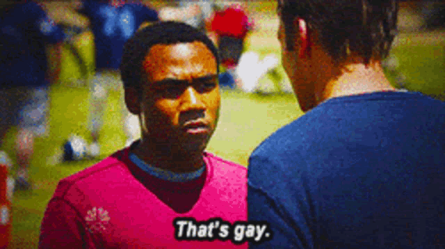 a man in a red shirt says that 's gay to another man in a blue shirt