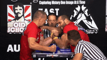 two men arm wrestling with the words capturing history one image at a time