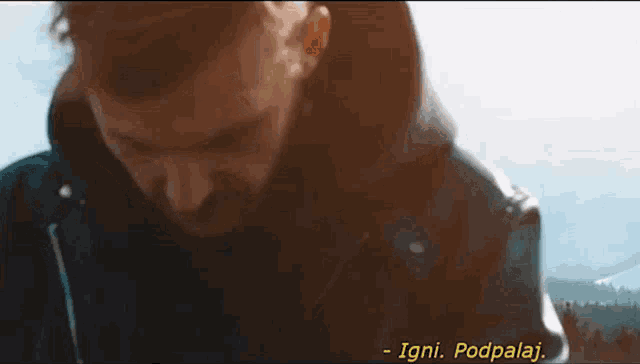 a close up of a man 's face with the words " igni podpalaj " written below him