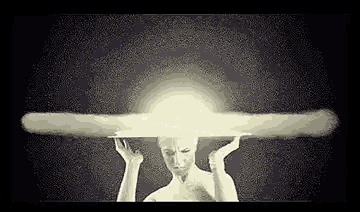 a naked woman is holding her head in front of a nuclear explosion .