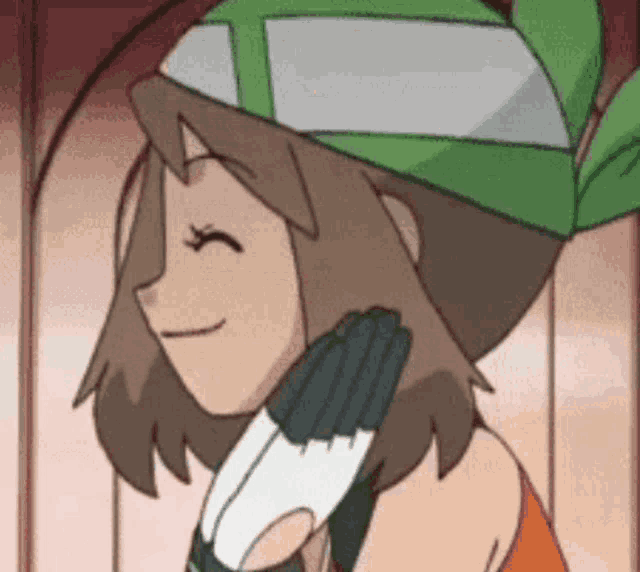 a cartoon girl wearing a green hat and gloves is smiling with her eyes closed .