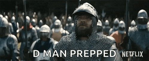 a man in chain mail is standing in front of a crowd of soldiers and says " d man prepped " .