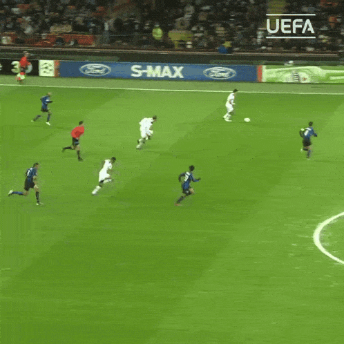 soccer players on a field with a sign that says enjoy responsibly on it