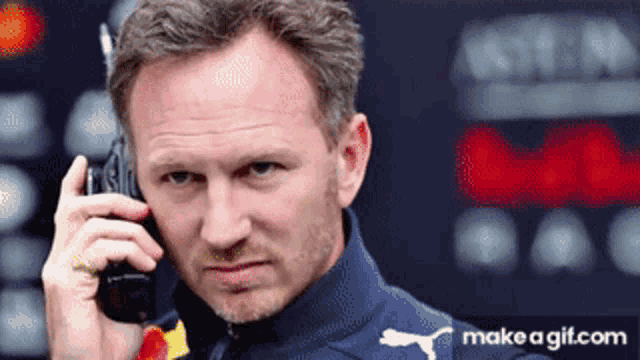 a man talking on a cell phone with a make a gif.com watermark on the bottom