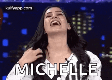 a woman is laughing with her mouth open and the word michelle is written on her face .